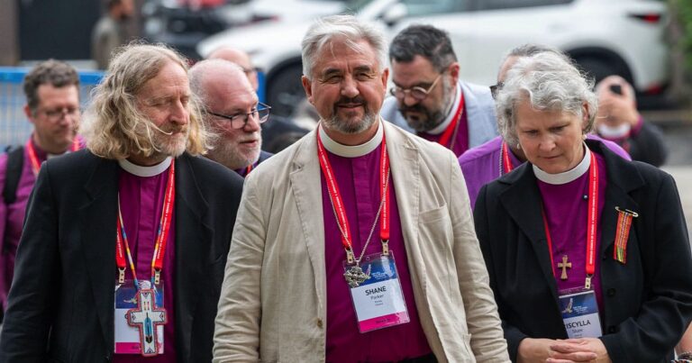 A group of male and female bishops walking outdoors.