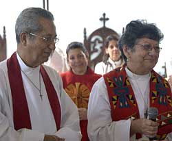 Cuba's two new suffragan bishops -- Archdeacon Ulises Prendes and Nerva Cot Aquilero -- leave St. Francis of Assisi church in Cardenas after the announcement of their appointment. In the background is Bishop elect Aquilera's daughter, Marianela, who was ordained priest the same day. VIANNEY CARRIERE