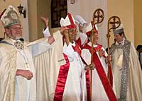 Archbishop Andrew Hutchison (left) introduces newly consecrated bishops Ulises Aguero and Nerva Cot as U.S. Presiding Bishop Katharine Jefferts Schori looks on. VIANNEY CARRIERE