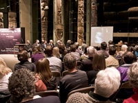 Audience and leaders watch a video clip on residential schools in the great hall of the Museum of Anthropology, Vancouver  WAYNE CHOSE