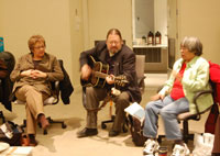 National Indigenous Anglican Bishop Mark MacDonald accompanies worship time at the March 2008 ACIP meeting. Members Freda Lepine (left) and Hannah Alexie (right) sing along. 