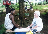 Lorna Reevely and a friend prepare cassava pudding in the Solomon Islands 