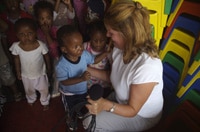 Bev Murphy, Anglican Journal circulation manager, embraces a preschooler at the John Wesley Centre, Etwatwa, South Africa.
