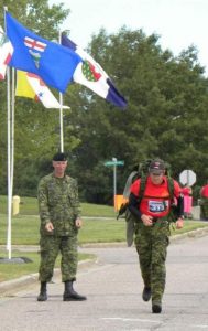 Padre Turner finishing the Iron Man with RSM CWO Bill Richards urging him on.