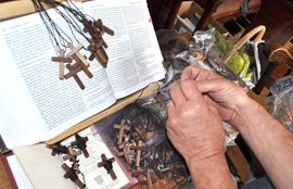 Fashioning wooden crosses for inmates