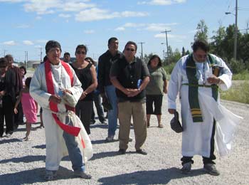 The Rev. Michael Chartrand (L) and the Ven. Larry Beardy (R) lead a prayer walk in Tataskweyak, Man., on July 22. ELIZABETH BEARDY