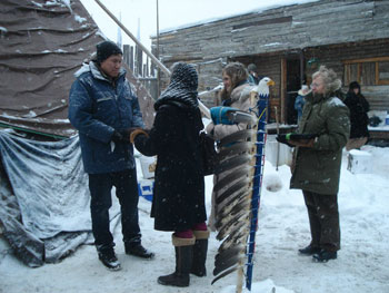 Kathryn Fournier, co-chair of the Living into Right Relations Task Group of the United Church of Canada presents tobacco to Chief Spence's representative (with KAIROS Executive Director Jennifer Henry and Fay Edmonds). KAIROS: CANADIAN ECUMENICAL JUSTICE INITIATIVES