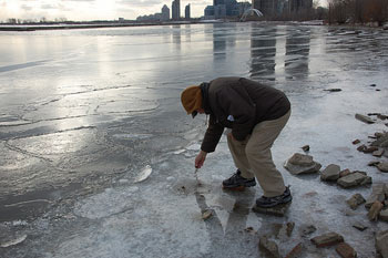 The Rev. Andrew Wesley makes an offering to Lake Ontario in an adaptation of the Eastern Orthodox Church’s Great Blessing of the Water. 