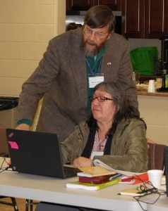 Translation project facilitator Bill Jancewicz assists Ruth Kitchekesik, deacon of St. Matthew's Anglican Church in Kingfisher Lake, Ont., as she translates the Bible into Oji-Cree.