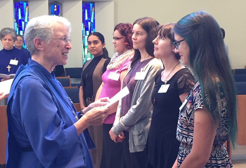 Sister Elizabeth Rolfe-Thomas, Reverend Mother for the Sisterhood of St. John the Divine, presents the Companions on the Way with individual crosses to wear.