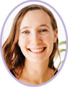 Headshot of Hannah Wygiera, smiling at the camera inside a soft purple oval frame.