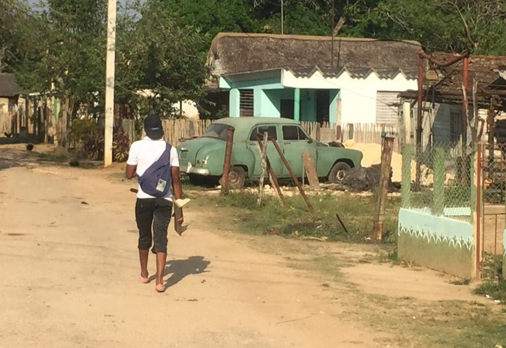 A local resident walks down a street in Itabo, Cuba.
