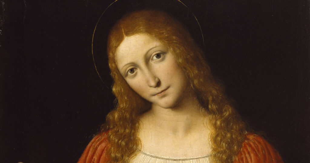 Portrait of a woman with long, wavy red hair and a serene expression, wearing a red garment and a dark halo, suggesting a religious or historical context.