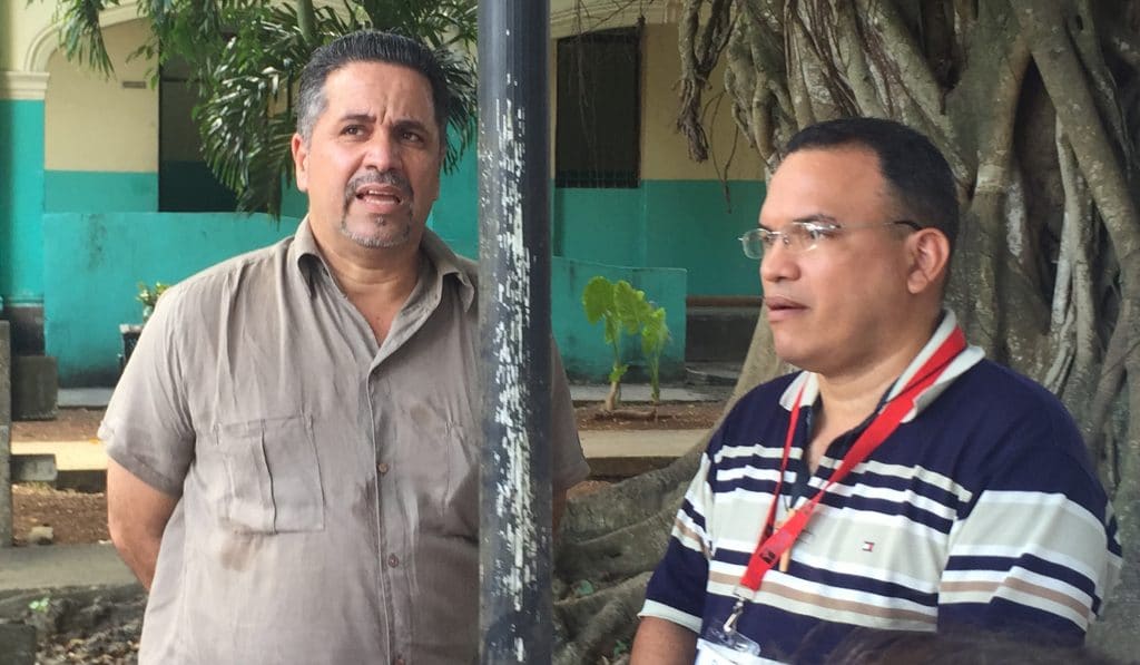 Dr. Francisco Mouza (left), director of the Colony shelter in Havana, Cuba, speaks about the facility as Justice Camp participant Gil Fat Yero translates from Spanish.
