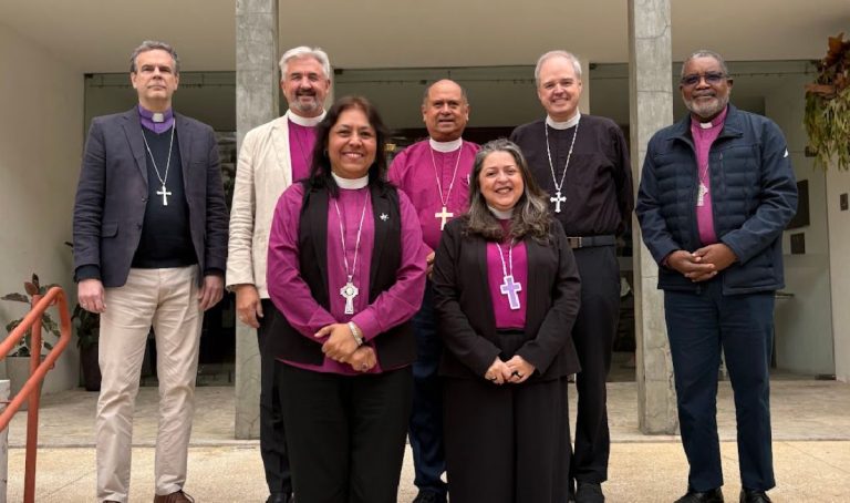 Back row (L-R): Presiding Bishop Brian Williams of the Anglican Church of South America, The primates of North, Central and South America stand in rows on concrete steps in front of a concrete building. They are: Back row (L-R): Presiding Bishop Brian Williams of the Anglican Church of South America, Archbishop Shane Parker, primate of the Anglican Church of Canada, Archbishop Juan David Alvarado Melgar, former archbishop of Guatemala, Presiding Bishop Sean Rowe of the Episcopal Church, Archbishop Philip Wright, Primate of the West Indies. Front row (L-R): Archbishop Alba Sally Sue Hernandez, primate of the Anglican Church of Mexico, Archbishop Marinez Bassotto, primate of the Anglican Church of Mexico