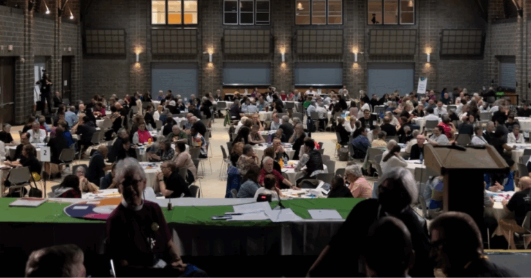 Image shows General Synod 2023 members pausing between presentations.