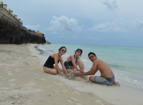 Left to right: Justice Camp participants Katelyn James, Sierra Robertson-Roper, and Jorge González Nuñez build a sand castle at a beach near Varadero.