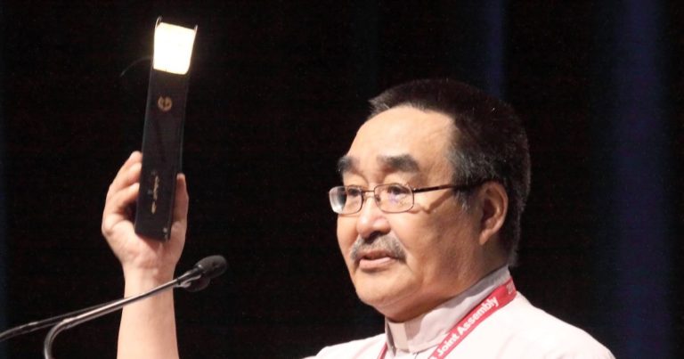 Allooloo displays a copy of the Inuktitut Bible at the 2013 Joint Assembly of the Anglican Church of Canada and the Evangelical Lutheran Church in Canada.