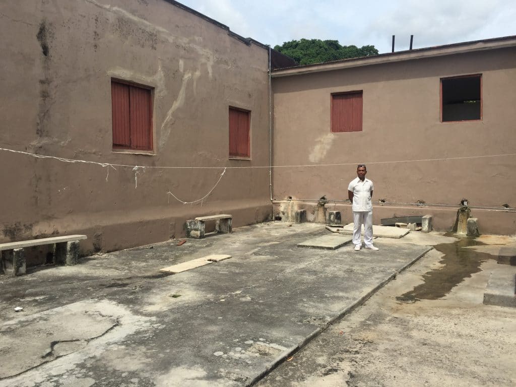 A staff member at the Colony shelter shows off the yard where residents congregate in the morning.