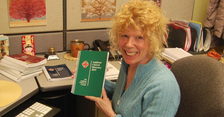 Project editor Janet Thomas holds up a copy of the 2015 Anglican Church Directory.