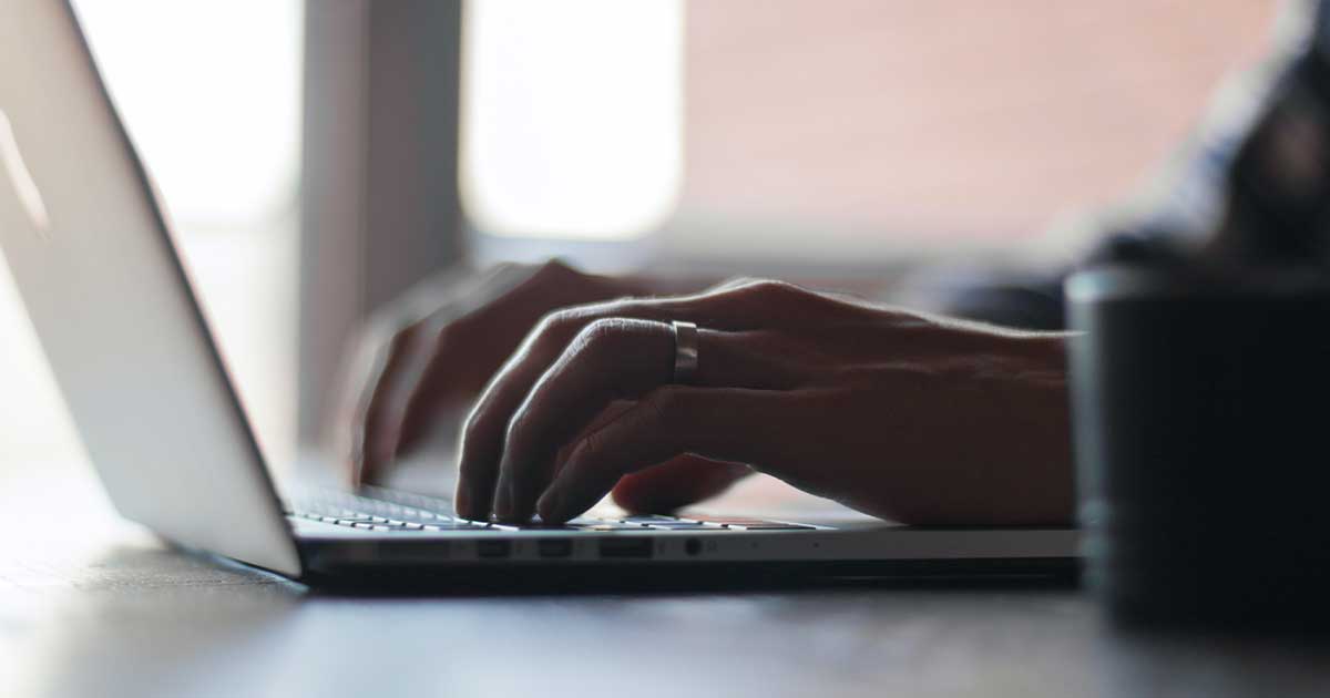 A man typing on a computer. Photo by Thomas Lefebvre on Unsplash