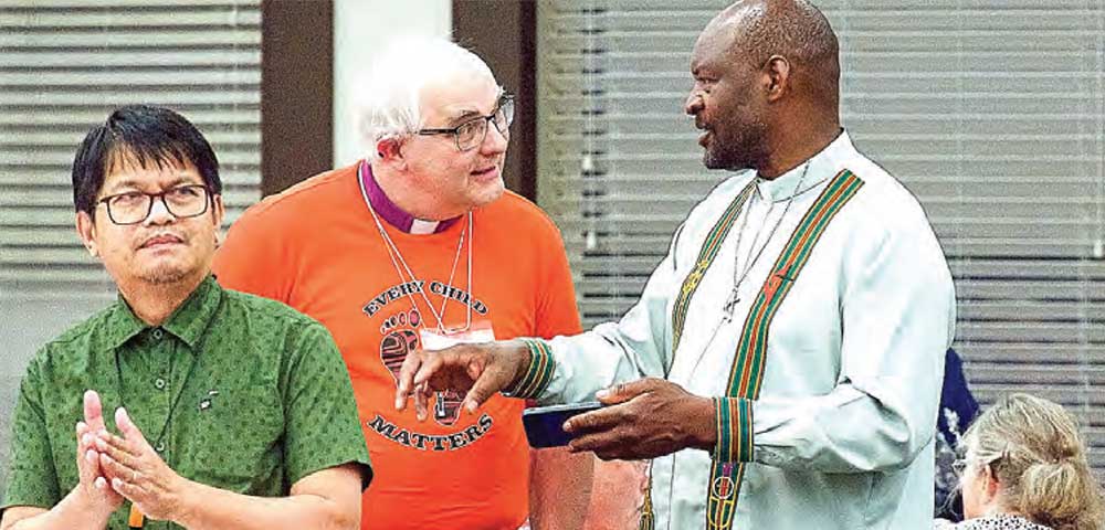 Bishop of Athabasca with priest and parishioners