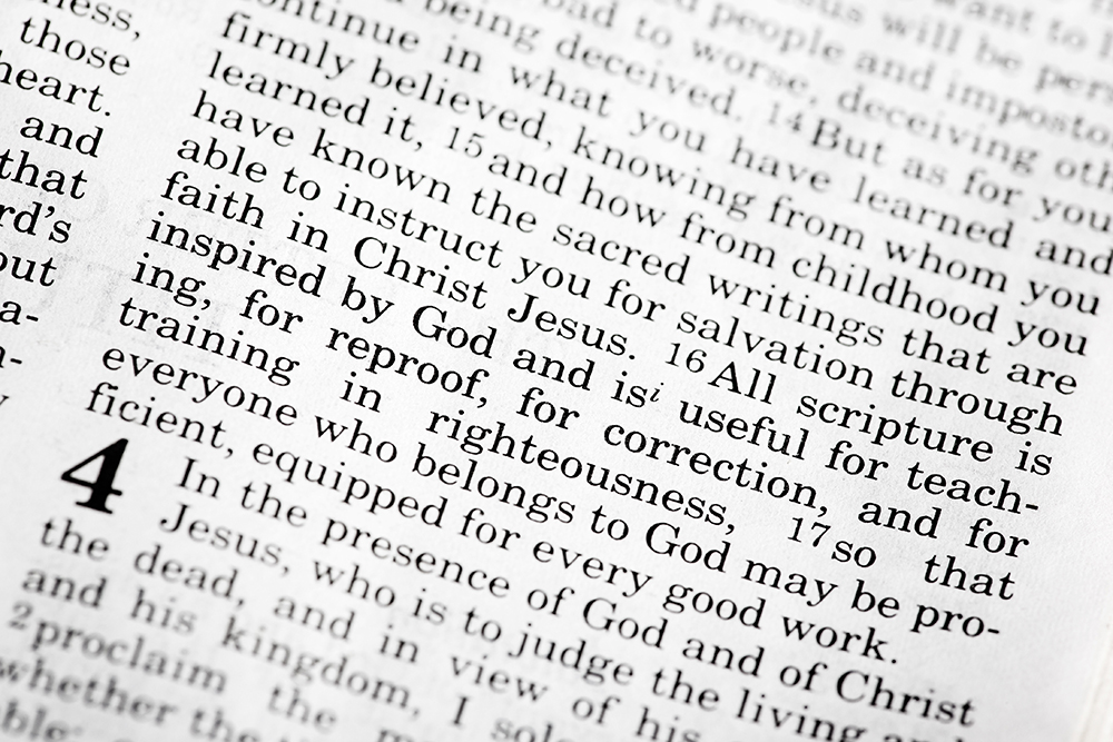 An open Bible page displays 2 Timothy 3:16.