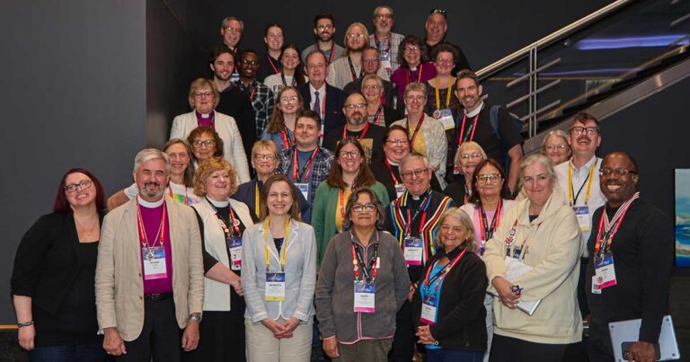 Group photograph of the Council of the General Synod (CoGS) 2025-2028 members standing on a staircase landing.