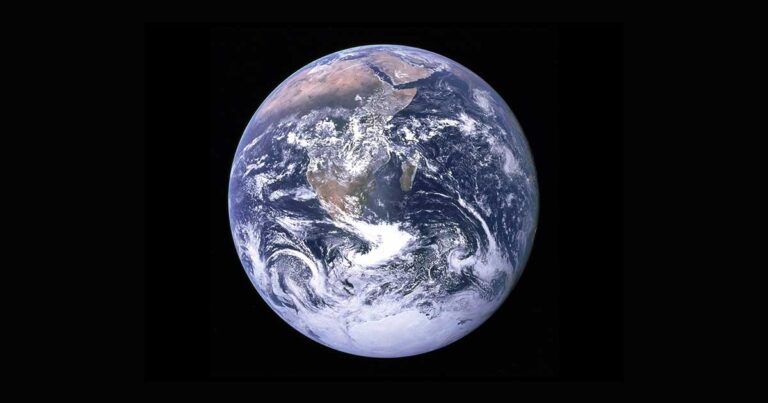 A view of planet Earth from space showing North America, Central America, and part of South America. The planet is surrounded by the blackness of space, with visible clouds swirling over blue oceans and green-brown continents.