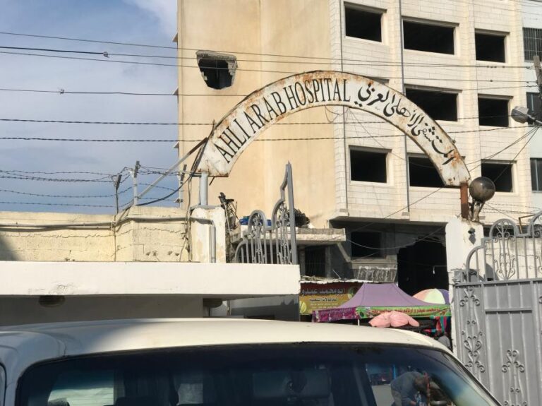 Hospital in the line of fire: a rocket leaves a gaping hole in a building across the street