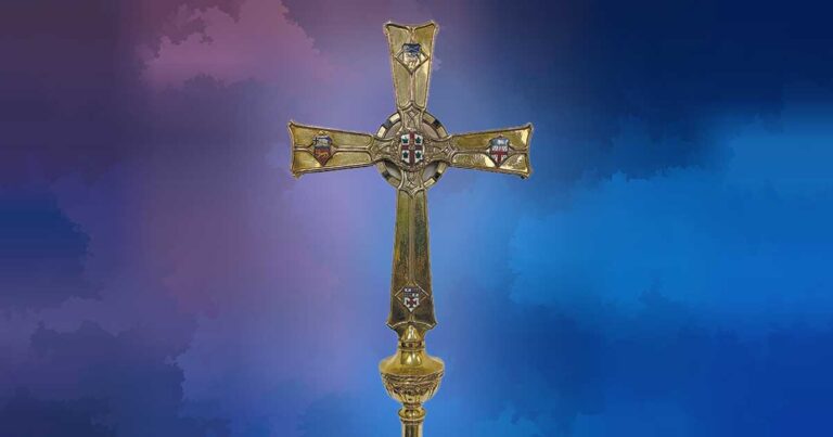 A decorative gold cross with intricate designs, set against a colorful gradient background.