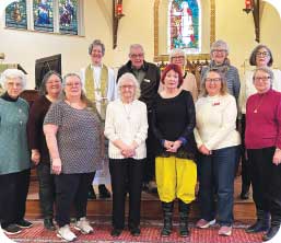 Group photo of people in front of an altar