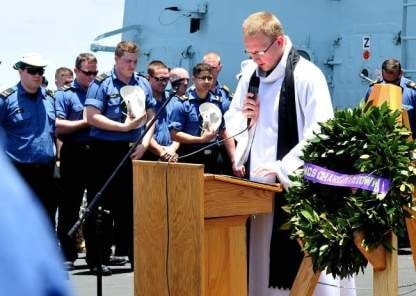 Padre John Hounsell-Drover leading the Battle of Atlantic worship service while deployed onboard HMCS Charlottetown.