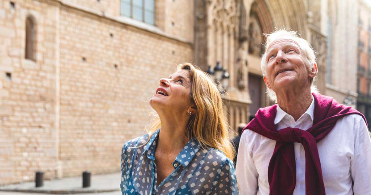 A couple travelling in Europe looking up