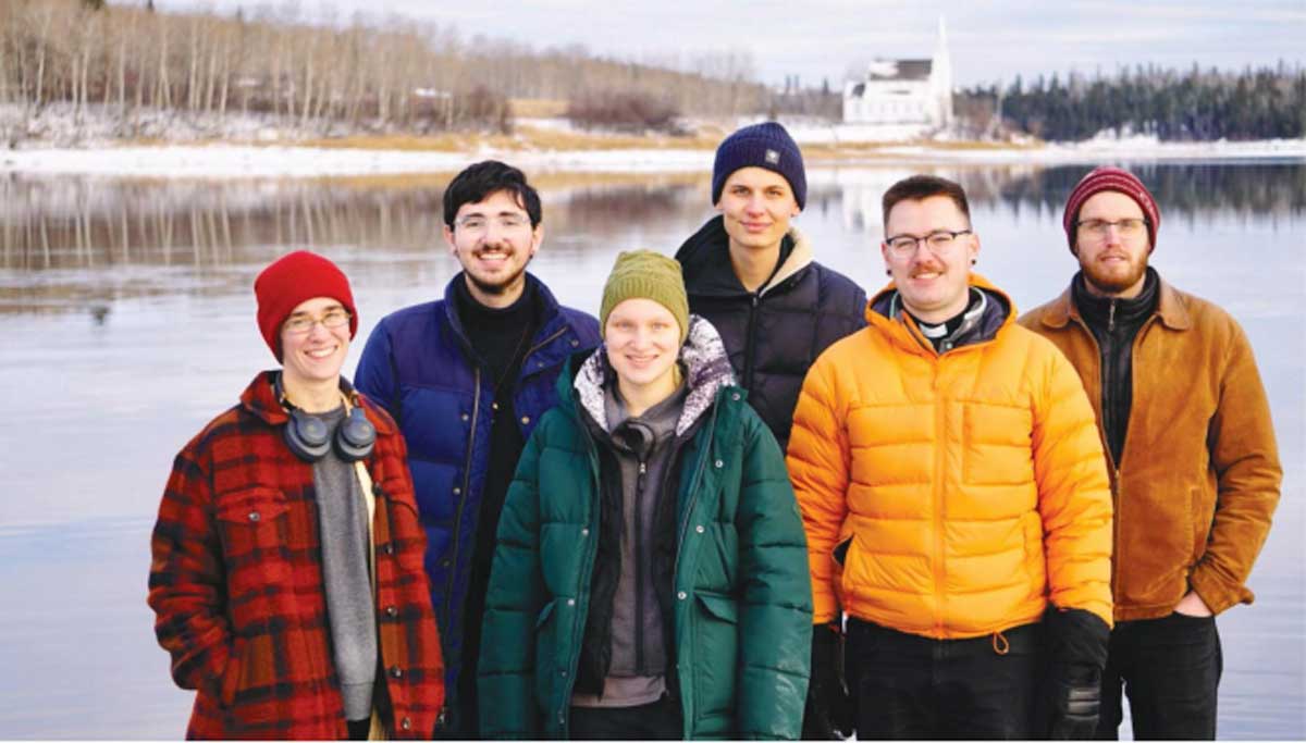 Photo of young people in front of Stanley Mission in northern Saskatchewan