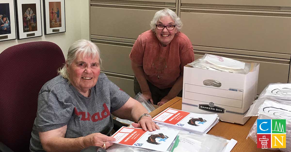 Volunteers help assemble kits for Bible Camp in a Bag.