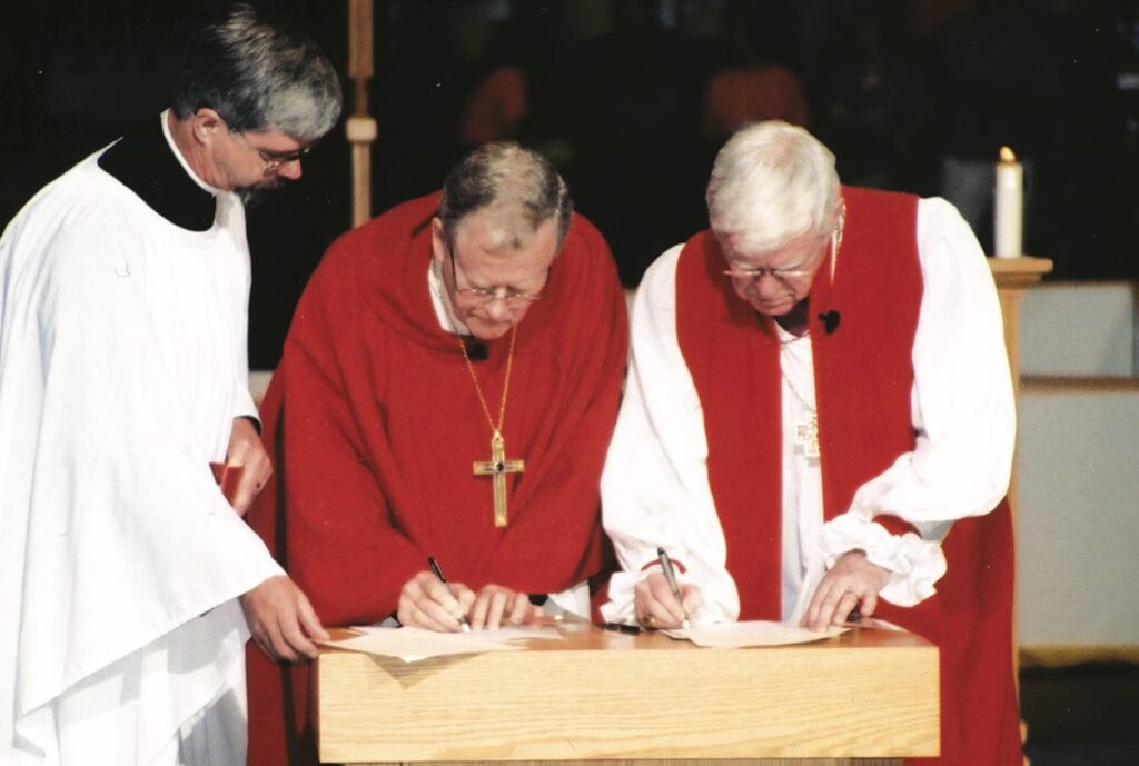 ELCIC National Bishop Telmor Sartison and Primate Michael Peers sign the Waterloo Declaration in July 2001